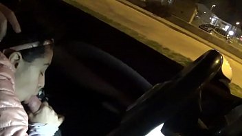 Dark-haired cutie gave a blowjob to a guy in a car in the middle of the street